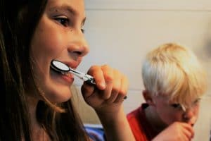 two kids brushing teeth