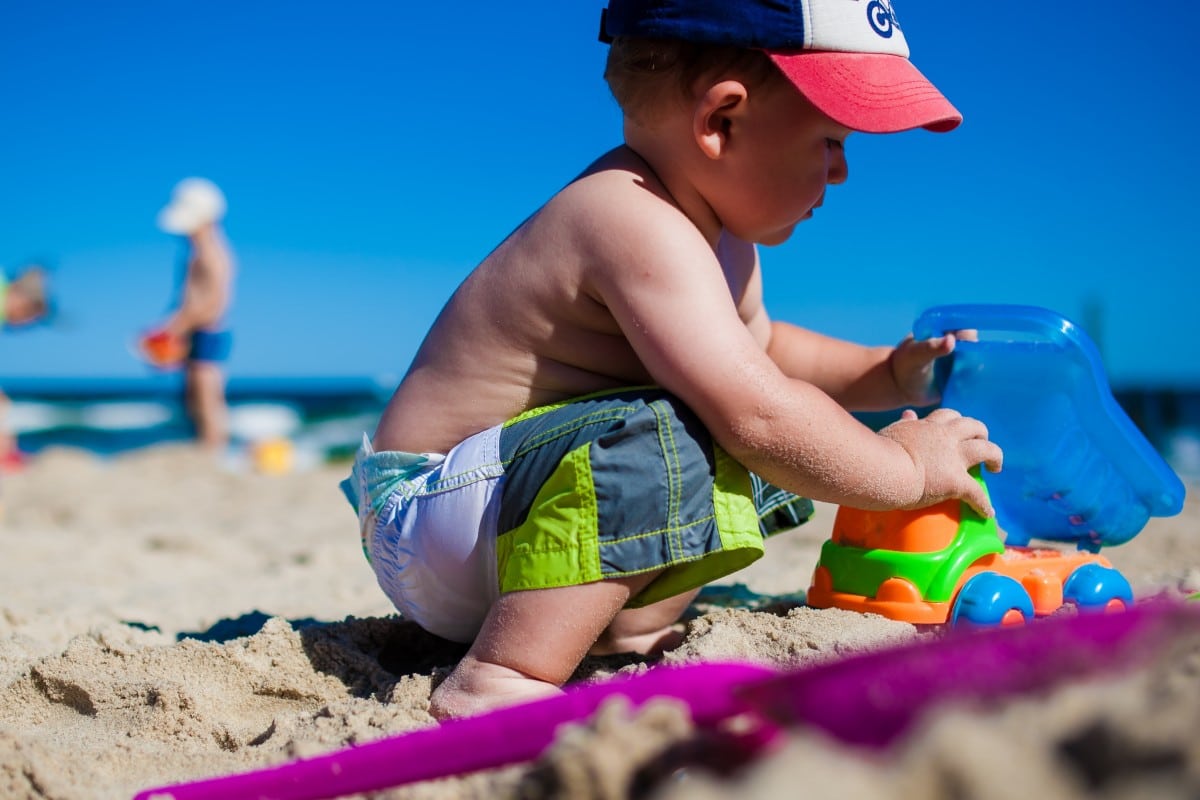 toddler playing beach